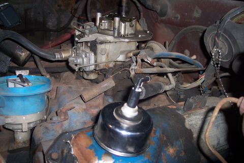 1978 Ford Bronco - Close-up view of an engine bay, a carburetor and distributor assembly with various hoses and wiring.