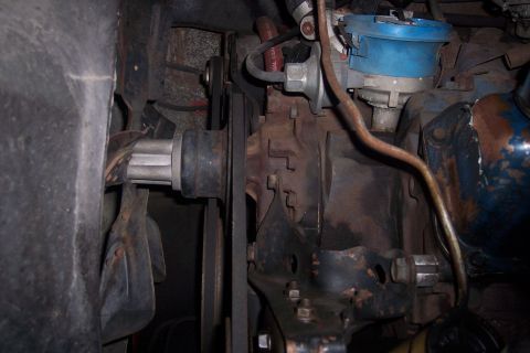 1978 Ford Bronco - Close-up view of engine components including the distributor, belts, and pulleys.