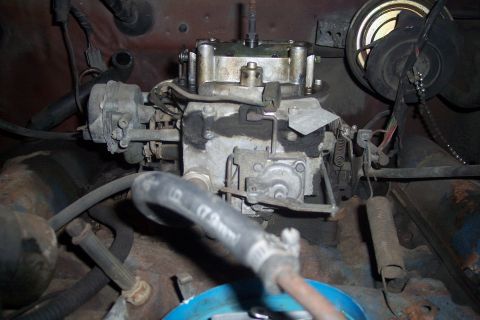 1978 Ford Bronco - Engine bay view of a carburetor and associated engine components.