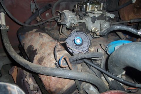 1978 Ford Bronco - Close-up view of an engine bay, focusing on the carburetor and distributor components.