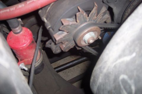 1978 Ford Bronco - This image shows a close-up view of a vehicle's engine components, including the alternator and drive belt.