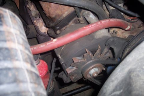 1978 Ford Bronco - Close-up view of an engine compartment, showing an alternator and associated hoses.