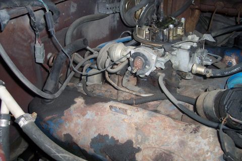 1978 Ford Bronco - Close-up view of a vehicle's engine bay, focusing on the carburetor and associated hoses.