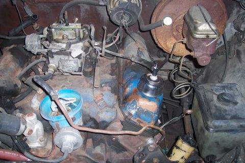 1978 Ford Bronco - Close-up view of an engine bay, focusing on the carburetor and associated components.