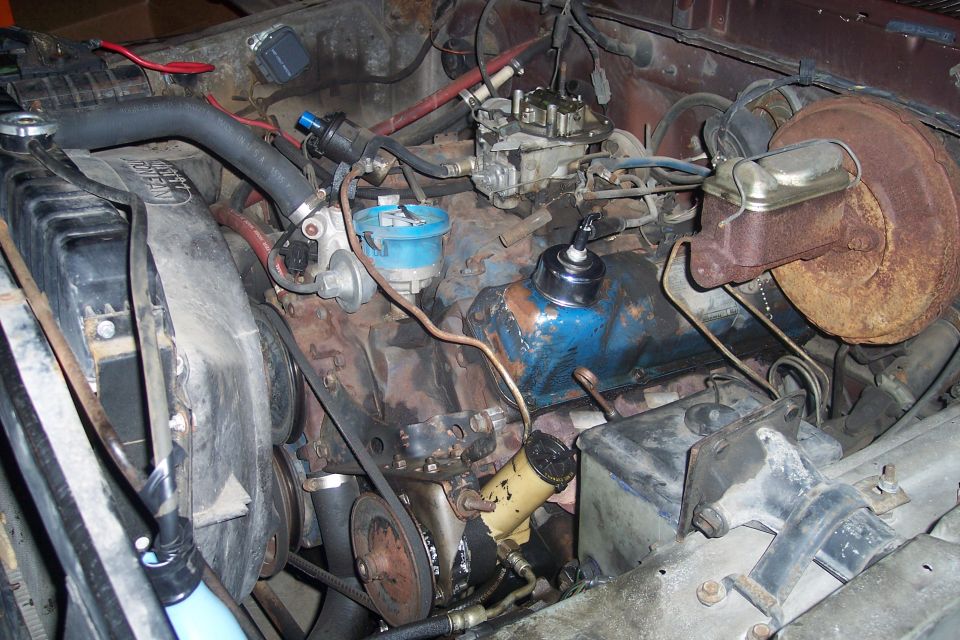 Engine bay with carburetor and brake booster
