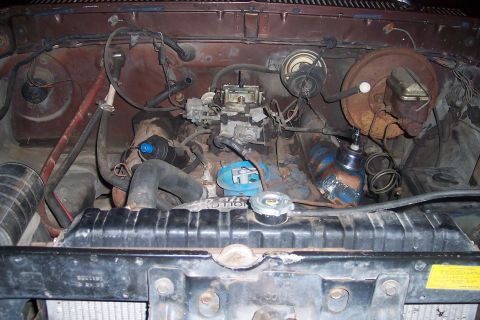 1978 Ford Bronco - Close-up view of an engine bay, focusing on the carburetor and surrounding components.