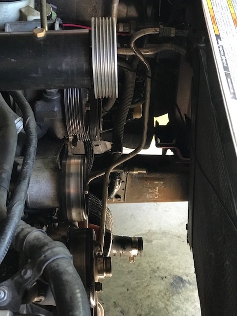 2000 Ford Explorer - Close-up view of engine pulleys and belts, likely part of an aftermarket supercharger system.