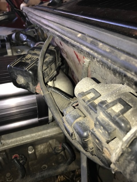 2000 Ford Explorer - Close-up view of engine compartment components, including electrical connectors and hoses.
