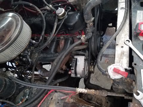 1985 Ford Bronco - Close-up view of a vehicle's engine bay, showing various components and a wrench near the radiator.