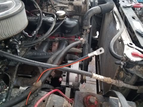 1985 Ford Bronco - Close-up view of an engine bay, focusing on the alternator and associated wiring.