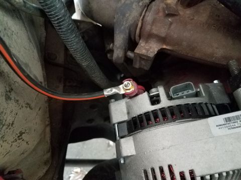 1985 Ford Bronco - Close-up view of an alternator with its wiring connected.