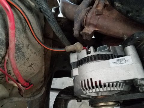 1985 Ford Bronco - Close-up of a remanufactured alternator, part number F1054AA 73 17104 M, with associated wiring.
