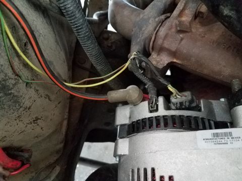 1985 Ford Bronco - Wiring connected to the alternator, showing a remanufactured unit from Mexico.