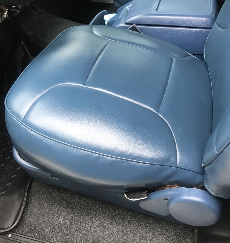 blue vinyl bucket seats and center console in a vehicle