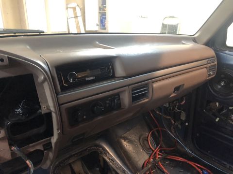 1995 Ford Bronco - Interior view of a 1995 Ford Bronco dashboard, showing an aftermarket stereo and exposed wiring during a redo.