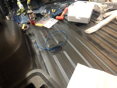 1995 Ford Bronco - The interior of a vehicle is shown with various tools and electrical wiring laid out on the floor, indicating ongoing work.