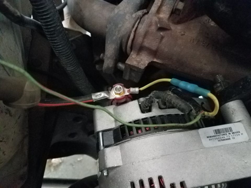 Close-up of alternator wiring with green and yellow wires connected