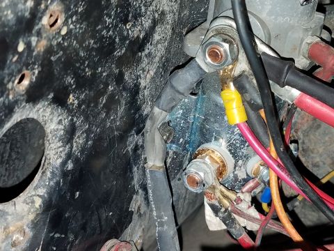 1985 Ford Bronco - Detail of vehicle electrical components and wiring, showing various connections and a blue residue.