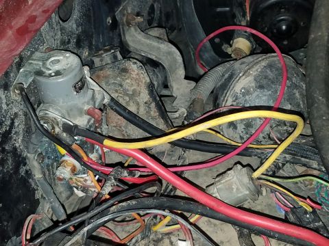 1985 Ford Bronco - Close-up view of a vehicle's starter motor and associated electrical wiring.