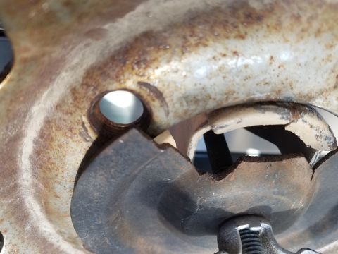 1985 Ford Bronco - A corroded metal part, possibly from a vehicle's undercarriage, shows significant damage and wear.