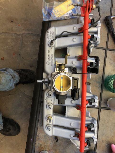 1992 Jeep Wrangler - Engine intake manifold assembly with throttle body, fuel rail, and injectors. Part numbers are visible.