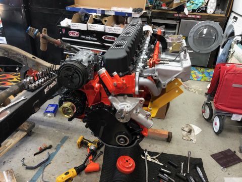 1992 Jeep Wrangler - Engine assembly in a garage setting with tools and equipment visible.