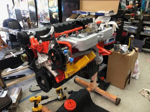 1992 Jeep Wrangler - Engine assembly on a stand in a workshop environment, surrounded by tools and parts.