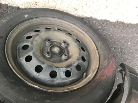 2008 Ford Focus - A close-up view of a spare tire, showing its steel wheel and tire tread against a rough surface.