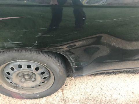 2008 Ford Focus - This dark green vehicle shows extensive damage to its rear quarter panel and a flat tire.