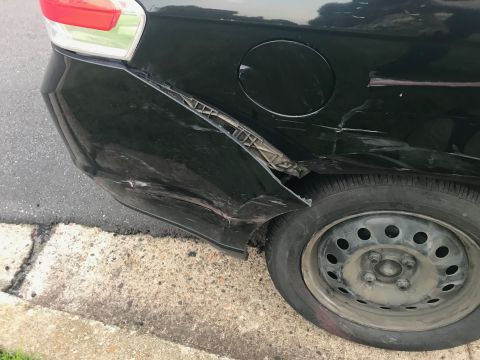 2008 Ford Focus - The rear quarter panel of a black 2008 Ford Focus shows extensive damage from an apparent collision.
