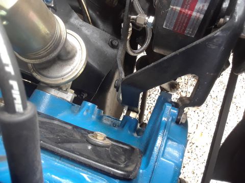 1985 Ford Bronco - Close-up view of an engine component with visible text on a fuel line and a label.