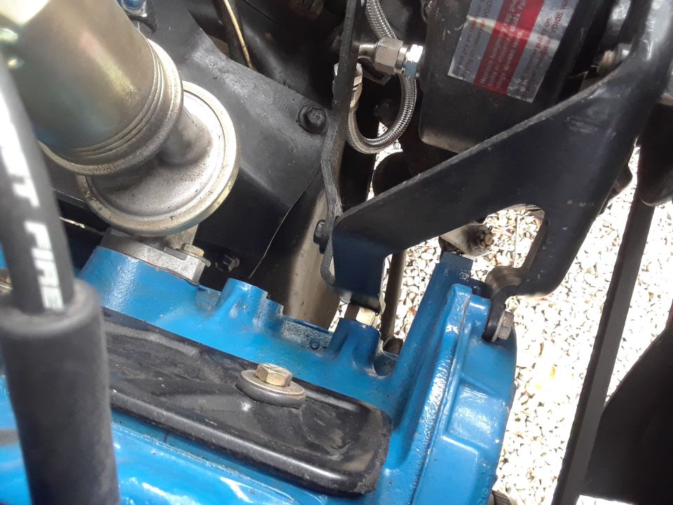 Blue engine block with metal bracket and fuel line