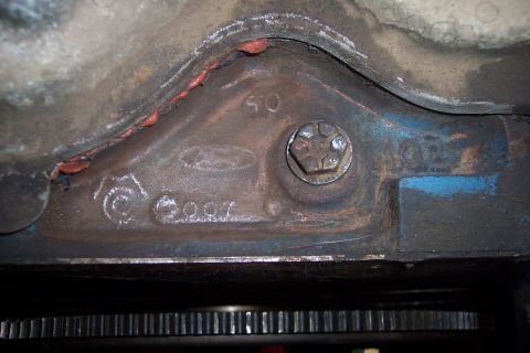 1978 Ford Bronco - A close-up view of an engine block casting shows stamped numbers and a Ford logo.