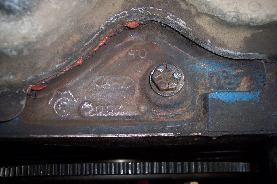 Close-up of engine block casting with numbers '2007' and a Ford logo visible