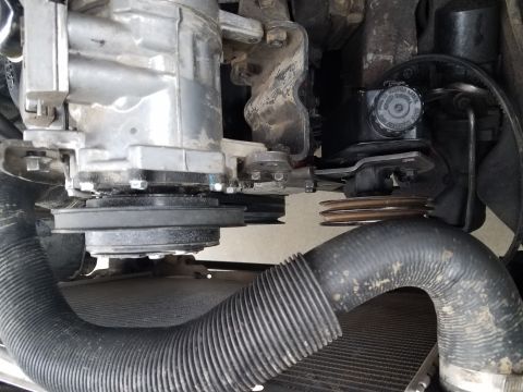 1985 Ford Bronco - Close-up view of engine components including pulleys, belts, and hoses.