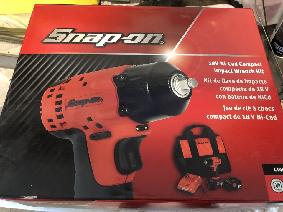 Red and black Snap-on 18V Ni-Cad Compact Impact Wrench Kit box with a tool, bag, and batteries visible