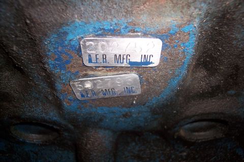 1978 Ford Bronco - Close-up of two metal identification tags affixed to a blue-painted surface.