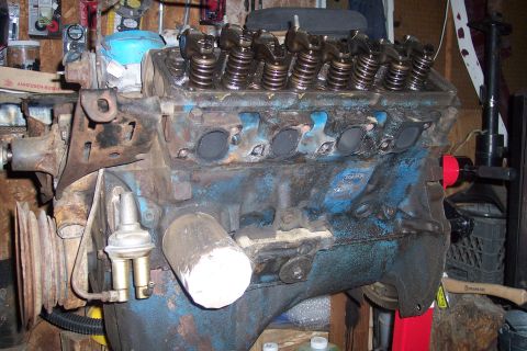 1978 Ford Bronco - Close-up of a V8 engine block with visible wear and tear, showing internal components.