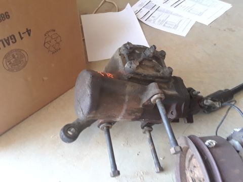 1994 Ford Bronco - A differential housing is shown with attached components and a cardboard box in the background.