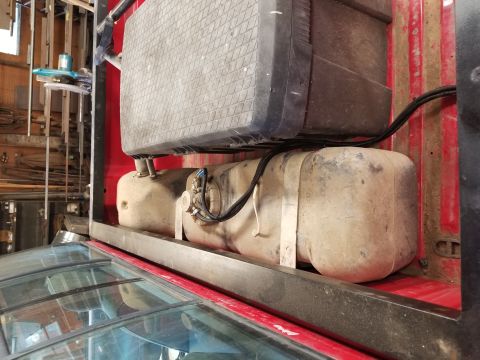 1996 Dodge 1500 - Close-up view of the fuel tank system installed in the bed of a red truck.