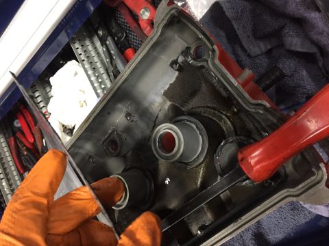 2000 Lotus Esprit - Engine valve cover removed, showing internal components and oil residue. Tools are nearby for maintenance.