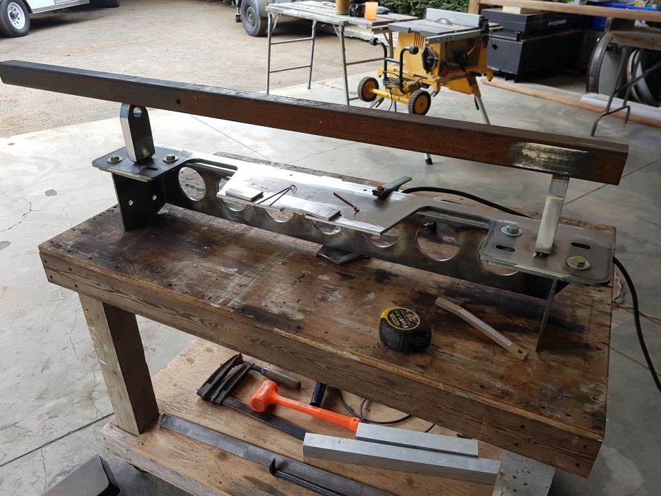 Custom fabricated metal part on a workbench with tools