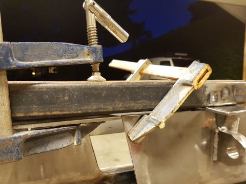 1978 Ford Bronco - Metal fabrication in progress, with clamps securing components. A vehicle is visible in the background.