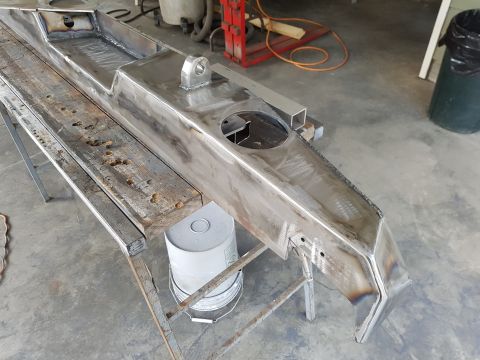1978 Ford Bronco - A custom-built bumper is shown on a workbench, ready for installation.