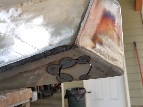 1978 Ford Bronco - A close-up view of a metal panel undergoing fabrication, with evidence of welding and precise cutouts.
