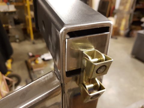 1978 Ford Bronco - A close-up view of a metal bracket with attached hinges, possibly a custom part or modification.