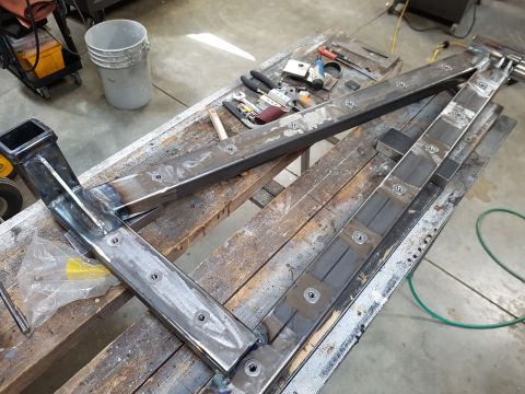 1978 Ford Bronco - Custom metal frame assembly in progress on a workbench with various tools.