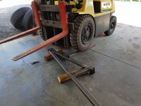 1978 Ford Bronco - A yellow Hyster forklift is parked on a concrete surface with its forks extended.