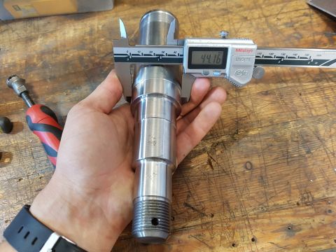 1978 Ford Bronco - Calipers are used to measure a metal component with a threaded end. The measurement shown is 44.16.