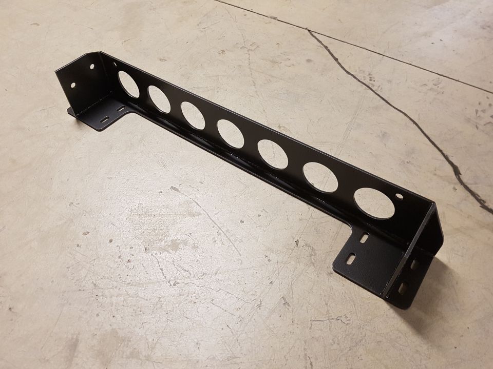 black metal bracket with seven circular holes and mounting tabs